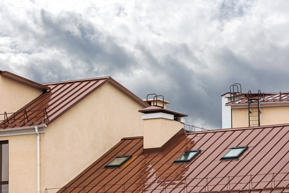 wet red metal roof with skylights during rain skylight leak rain